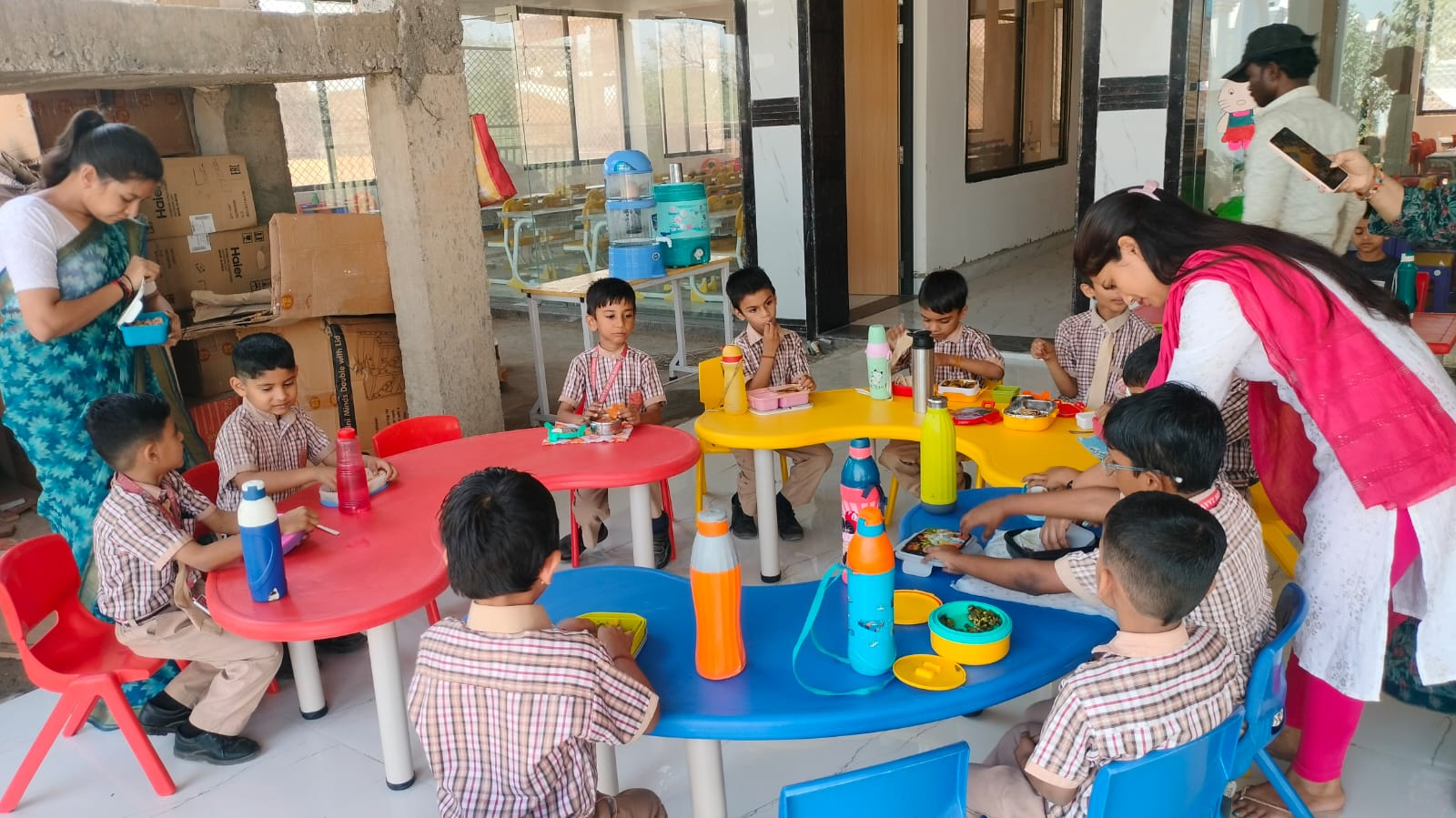 Teacher guiding children during classroom activity