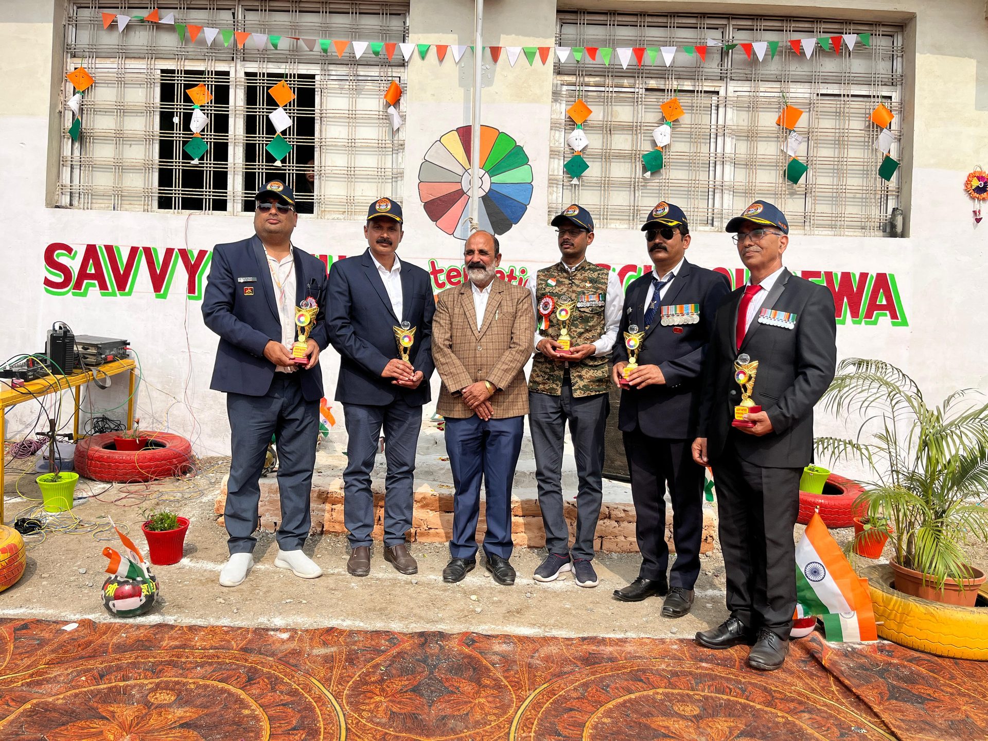 Guests with trophies in the decorated school courtyard