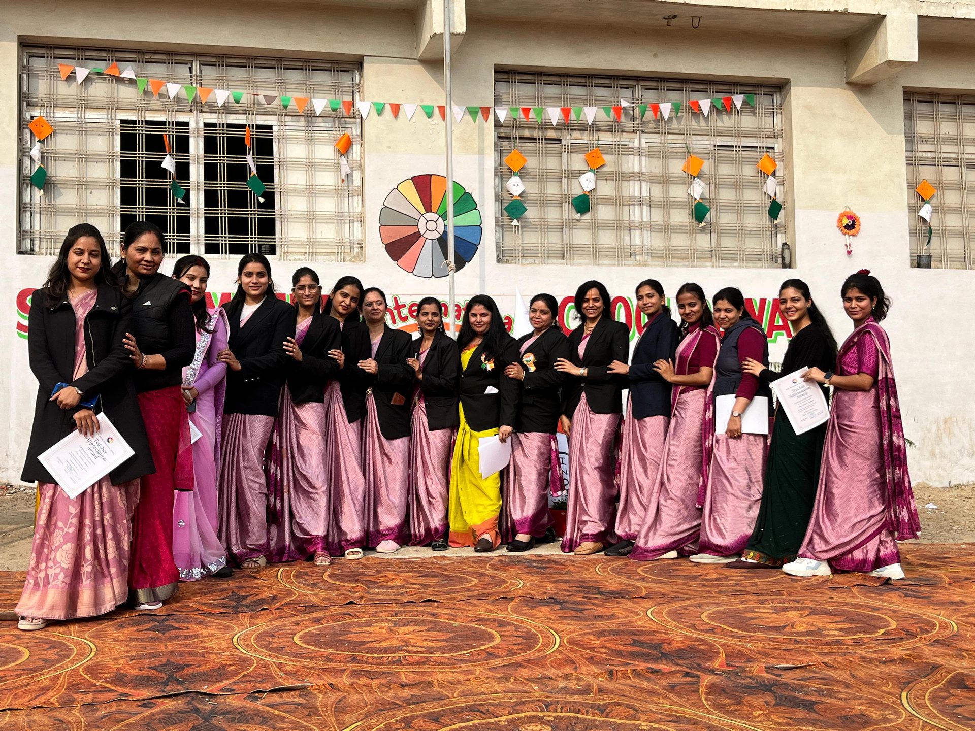 Teachers and guests holding appreciation certificates