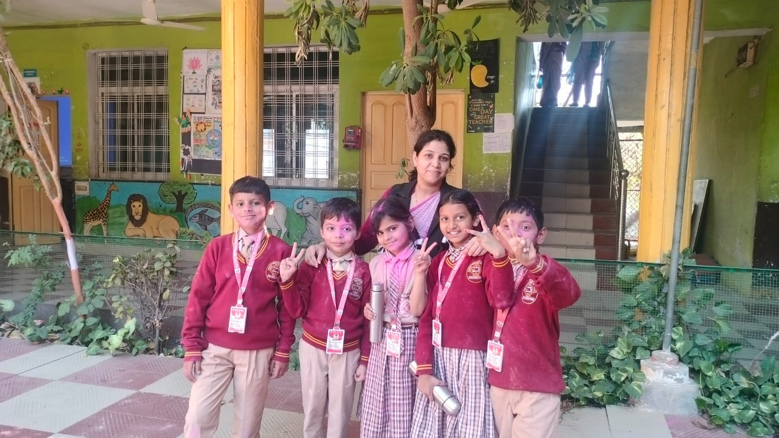 Teacher with students in the school courtyard