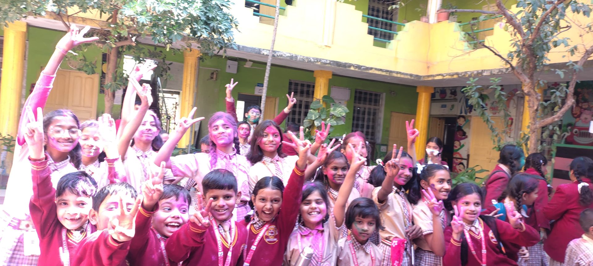 Students smiling during a colour celebration