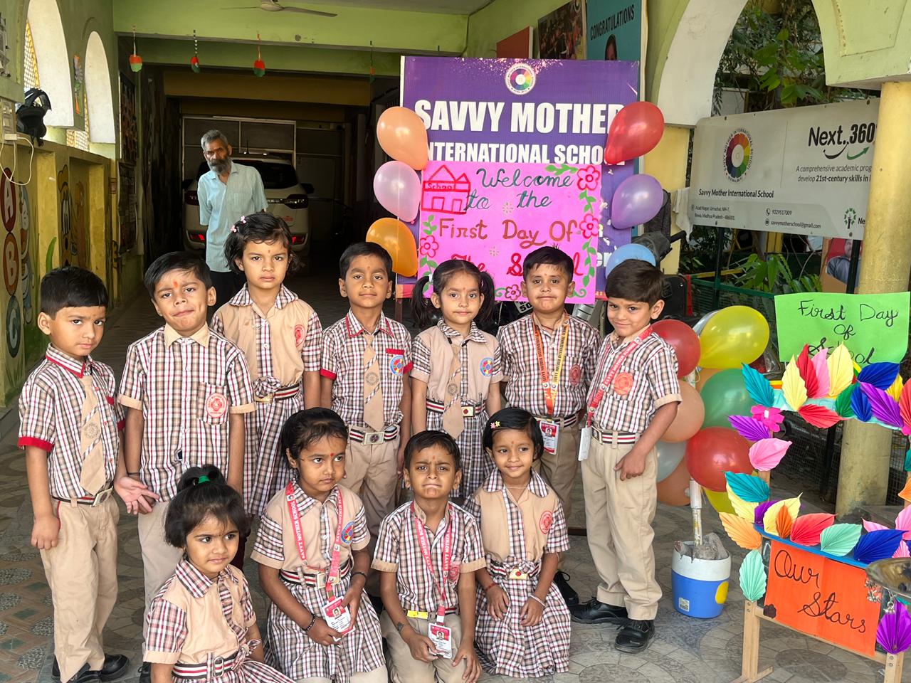 Young students posing near first day school decorations