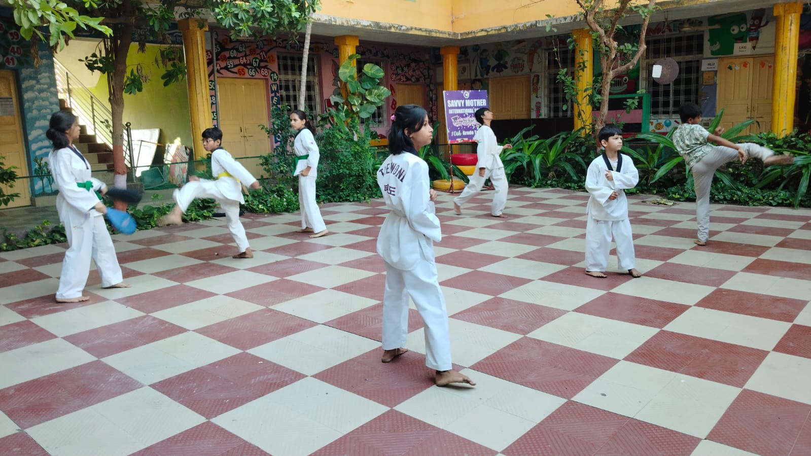 Students practicing taekwondo in the school courtyard
